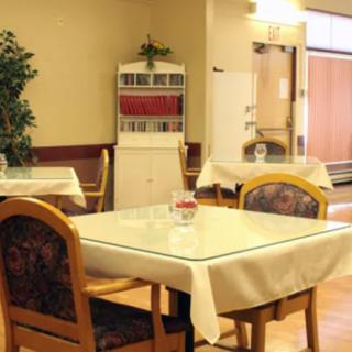A cozy dining area with tables and chairs arranged neatly.