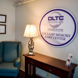 Interior of a memory care facility with signage and comfortable seating.