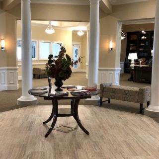 Elegant lobby area with central table and decorative elements.