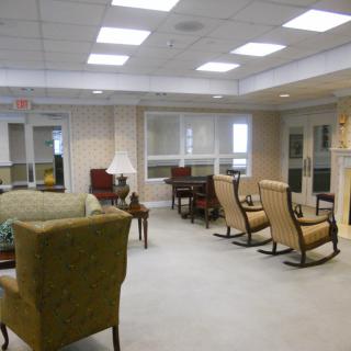 A modern lounge area with comfortable seating and rocking chairs.