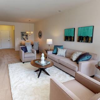 A modern living room with stylish furniture and vibrant artwork.