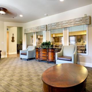 A spacious living room with modern furniture and elegant decor.