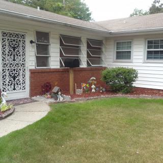 A suburban house with a well-maintained front yard and decorative elements.