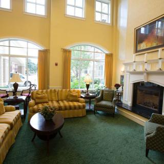 A cozy living room with comfortable seating and a large fireplace.