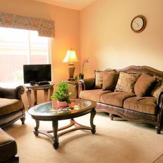 A cozy living room with classic furniture and warm lighting.