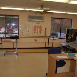 A physical therapy room equipped with rehabilitation tools and exercise equipment.