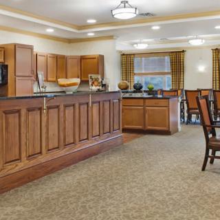 Spacious kitchen and dining area with wooden cabinets and warm lighting.