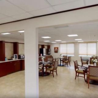 A modern office interior with meeting tables and chairs.