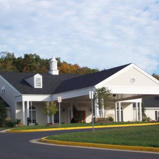 A suburban residential building with a well-maintained exterior and surrounding greenery.