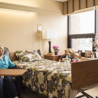A cozy bedroom in a care facility, showcasing the companionship of an elderly resident.