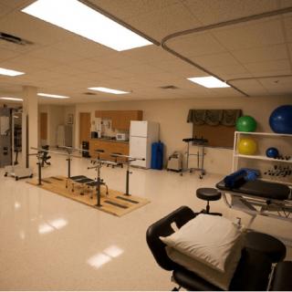 A physical therapy and rehabilitation clinic with various exercise equipment.