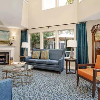Spacious living room with elegant furniture and cozy fireplace.