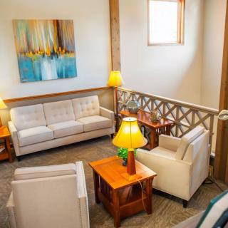 A cozy living room with stylish furniture and artwork on the wall.