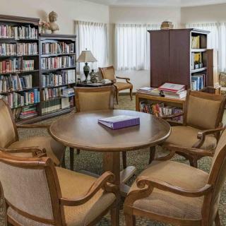 A cozy library reading area with bookshelves and comfortable seating.