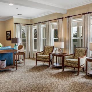 A well-lit living room with elegant furniture and large windows.
