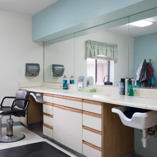 A modern barber salon interior featuring a styling chair and well-organized work area.