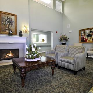 A cozy living room with a fireplace and comfortable seating arrangements.