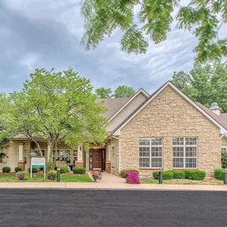 A suburban house with a brick exterior and a well-maintained front yard.