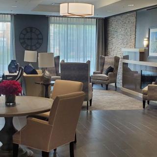 A modern and elegantly designed living room with comfortable seating and tasteful decor.