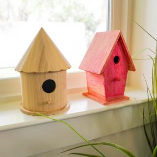 A charming collection of wooden birdhouses displayed on a windowsill.