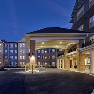 Elegant hotel entrance illuminated at night.