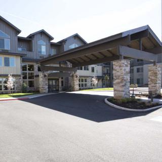 A modern residential building with a covered entrance.
