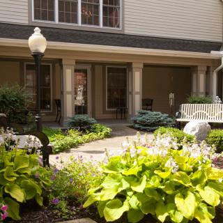 A well-maintained courtyard garden with lush greenery and seating areas.