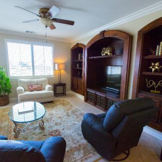 A cozy living room with comfortable seating and built-in bookshelves.