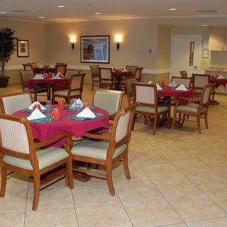 An empty dining room with tables set for guests.