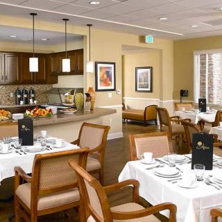 An elegantly arranged dining room with well-set tables and comfortable seating.