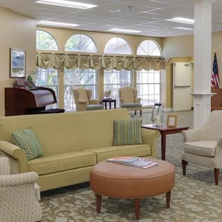 A cozy living room with comfortable seating, large windows, and elegant decor.