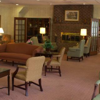 A cozy living room featuring comfortable seating, a fireplace, and warm lighting.