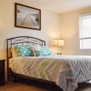 A cozy and well-decorated bedroom with a neatly made bed.