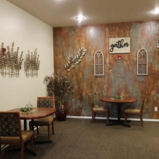 A cozy restaurant interior featuring wall art and neatly arranged tables and chairs.
