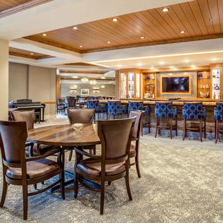 Upscale restaurant interior with a bar and seating area.