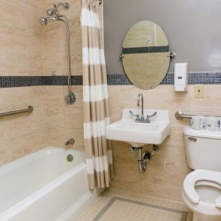 A well-organized bathroom with a bathtub, sink, and toilet.