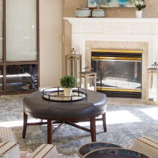 A cozy and modern living room featuring a stylish coffee table and an elegant fireplace.