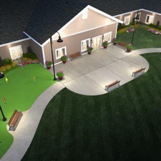 A serene outdoor area featuring a well-lit building surrounded by manicured lawns and benches.