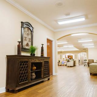 A warmly lit hallway with elegant decor and wooden furniture.