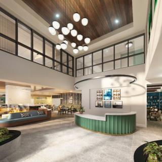 A modern and stylish hotel lobby with a reception desk and cozy seating area.