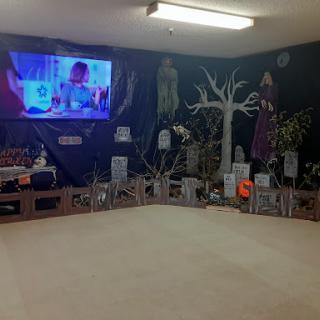 A creatively decorated room showcasing Halloween-themed elements and wall art.