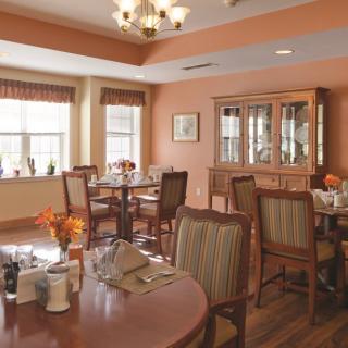 A cozy dining area with neatly set tables and comfortable seating.