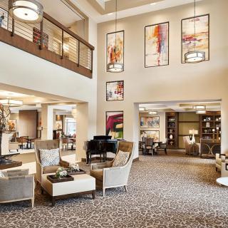 A stylish and modern lobby featuring comfortable seating, contemporary artwork, and elegant lighting.
