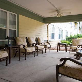 A cozy outdoor patio area with cushioned chairs arranged for relaxation.