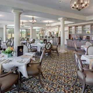 An elegant restaurant interior with beautifully arranged tables and chairs, ready for dining.