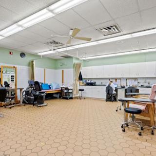 A spacious and well-organized treatment room in a medical clinic, designed for patient care.