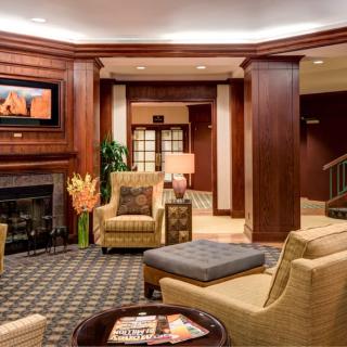 A warm and inviting hotel lobby with comfortable seating and a fireplace.