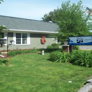 A well-maintained residential property showcasing a neat front yard and clear signage.