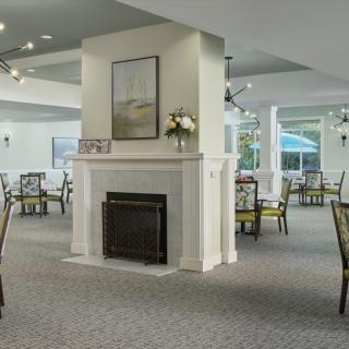 Elegant dining area with a central fireplace and stylish decor.
