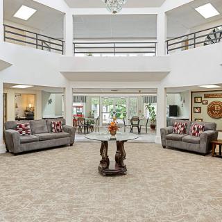 Spacious lobby with modern sofas and decorative elements.